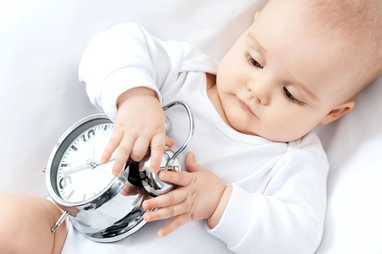 Baby and large alarm clock
