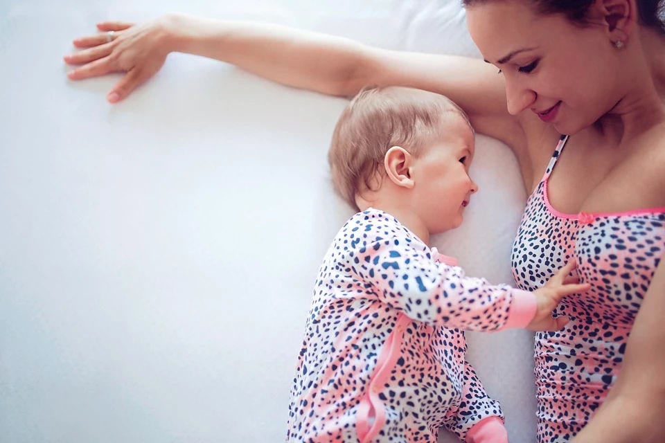 mum and baby on bed