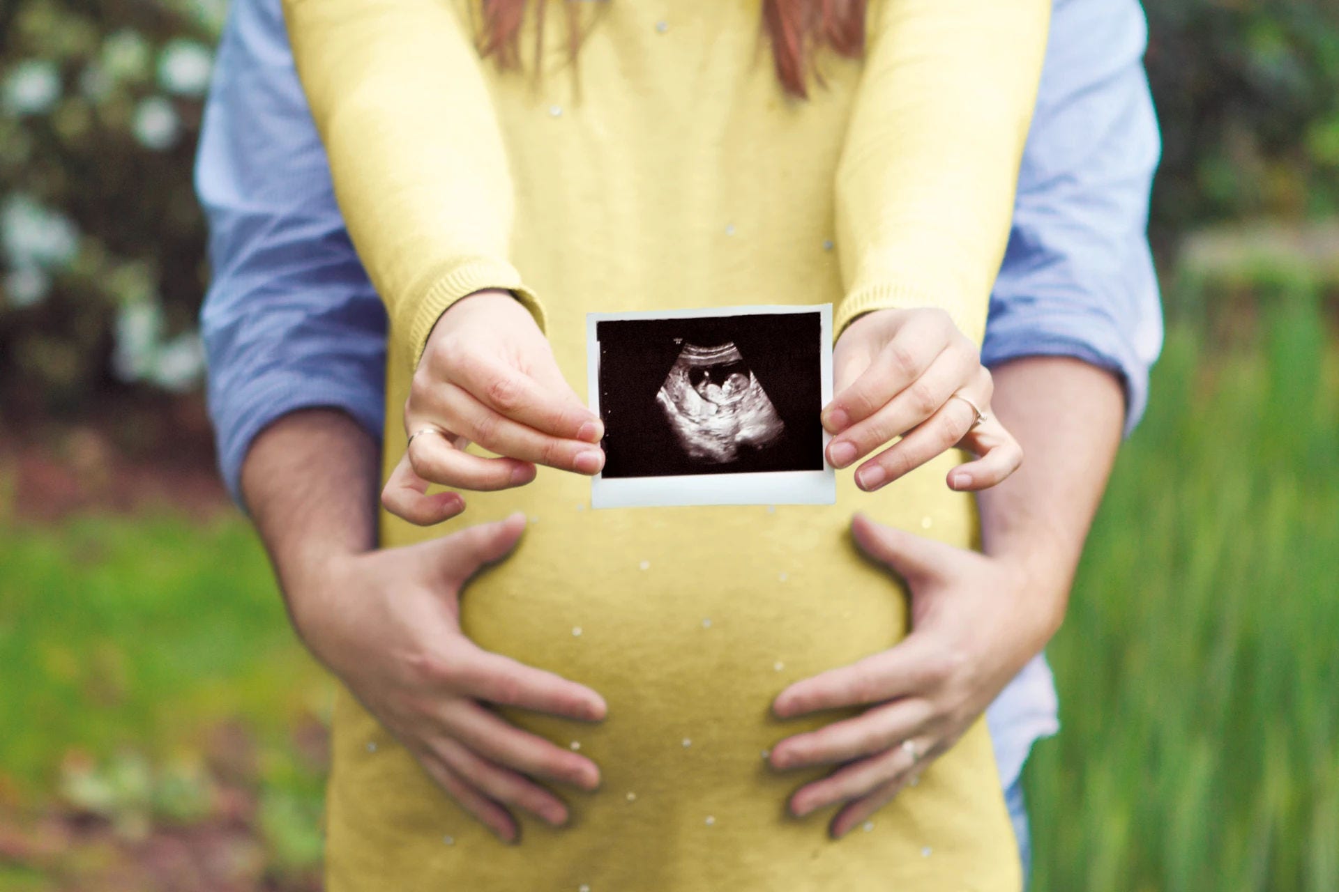 pregnant holding baby scan